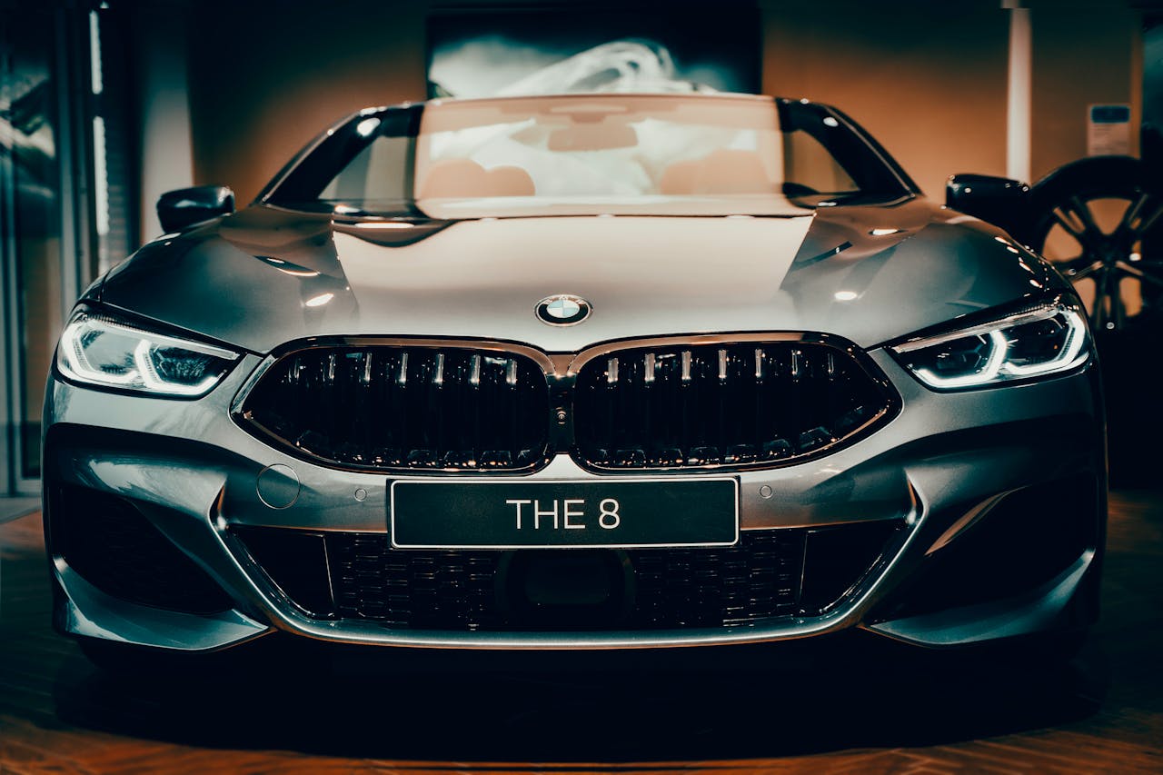 Front view of a shiny luxury BMW car with distinctive headlights and emblem.