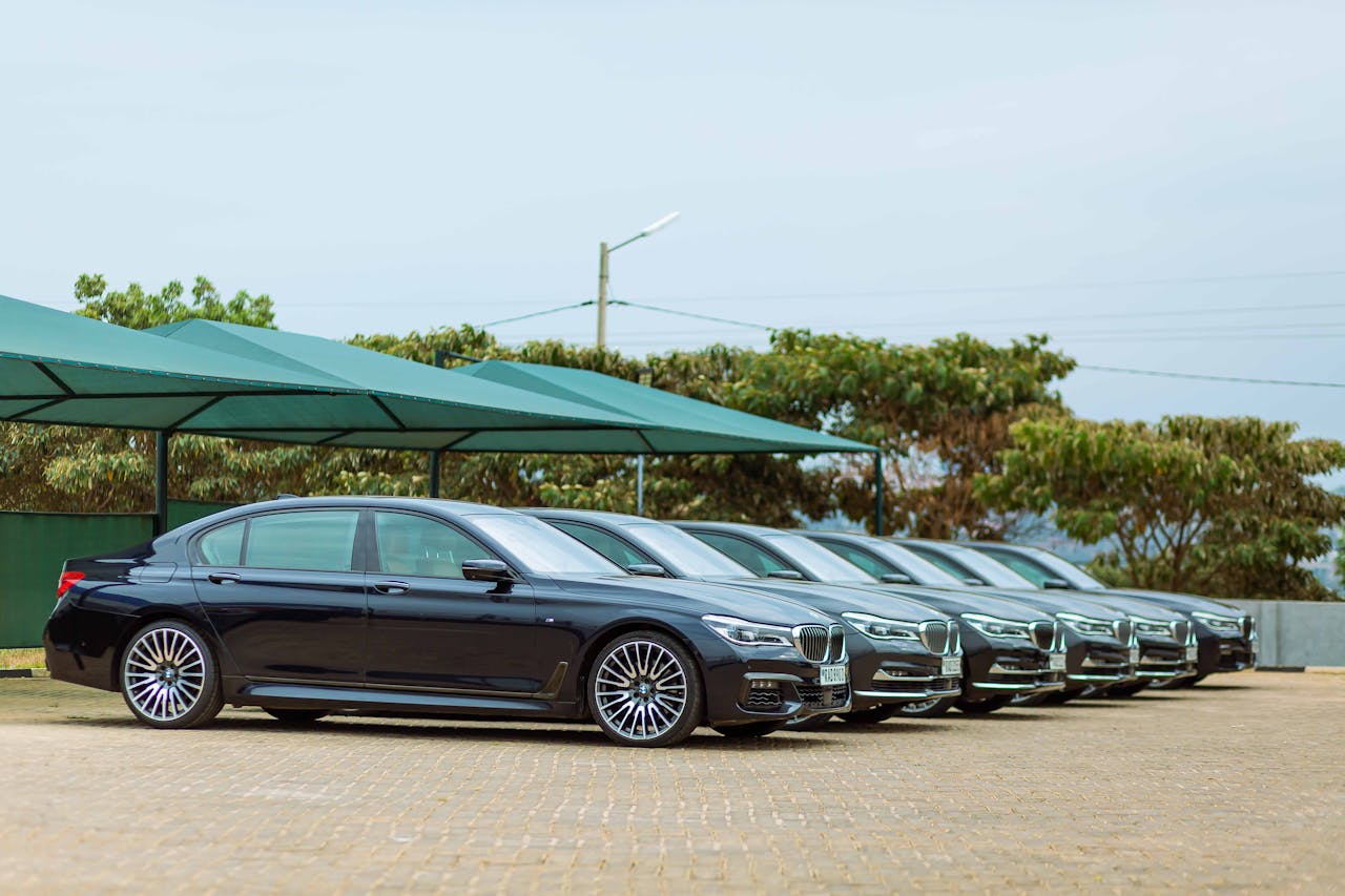 Lineup of luxury BMW Series 7 cars parked outdoors, showcasing elegance and style.